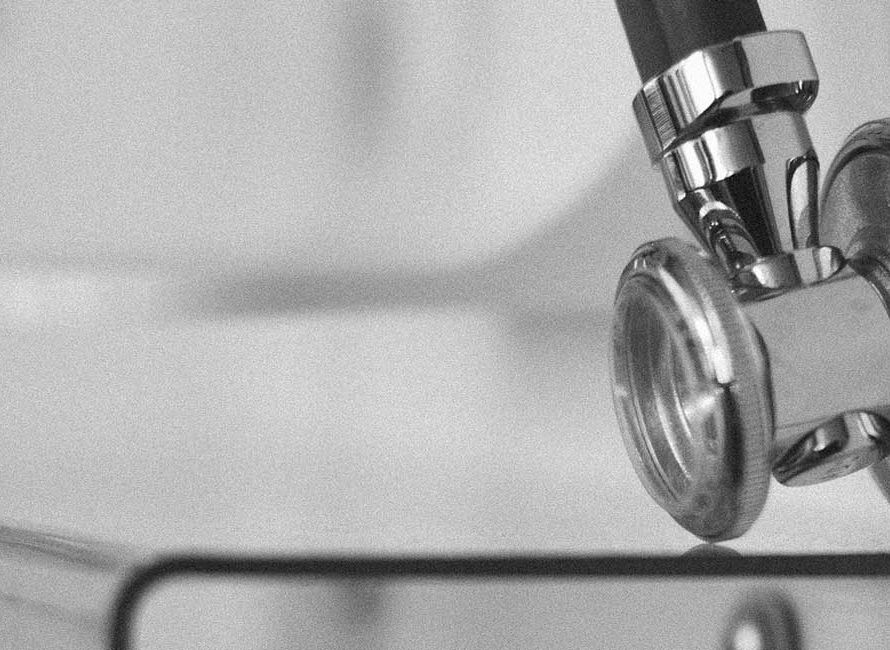 A monochrome image of a stethoscope, showcasing its iconic shape and design